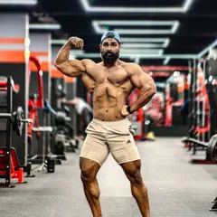 The front double bicep pose is a staple in bodybuilding. This shot displays arm development, back width, a tight waist, and quad separation, all key elements a judge looks for.