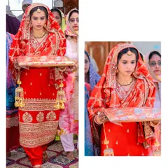 A full view of the bride's grand entrance. Her traditional red Punjabi suit, complete with chooda and kalira, makes for a stunning and regal bridal look.
