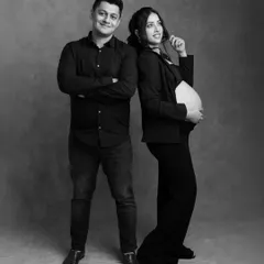 A fun and modern pose for an expecting couple. Their back-to-back stance and confident smiles give this black and white maternity photo a cool, contemporary feel.