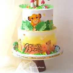 I brought the Pride Lands to life with this two-tier Lion King birthday cake. It features a warm sunset-coloured buttercream ombre, edible images of Simba, and jungle-themed details like leaves and mushrooms, making it a great centrepiece for a jungle party.