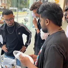 Collaboration is key. Here, we're discussing design ideas directly with customers at our live art station. This personal interaction ensures every person walks away with a custom piece they truly love.