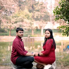 A classic pre-wedding pose by the water in Lodhi Garden. The couple is holding hands, creating a simple yet timeless romantic portrait.