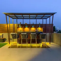 A close-up of a romantic and stylish bar setup. The design features a wooden back shelf with the word "LOVE," under-counter lighting, and elegant bar stools, perfect for evening cocktails.