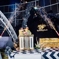 This image captures the peak of the celebration, with two cold pyro cannons creating a celebratory arch over the birthday cake. It's a fantastic photo opportunity for everyone.