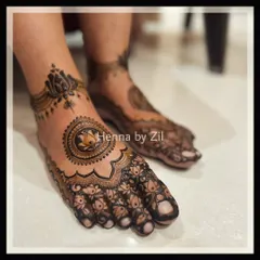 An elegant and intricate foot design featuring a central lotus mandala. This was created to match the bride's symmetrical hand mehendi.