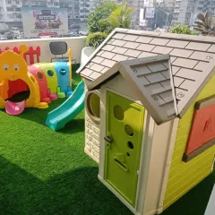 Even a balcony can become a mini-playground. This setup includes a playhouse, a caterpillar tunnel for crawling adventures, and a small slide, proving you don't need a huge lawn to create a fun zone for your kids.