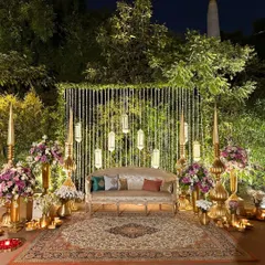I believe a backdrop should be more than just a photo spot, it should be a piece of art. Here, soft lights, warm brass, and lush florals come together to create a perfect stage for wedding memories.