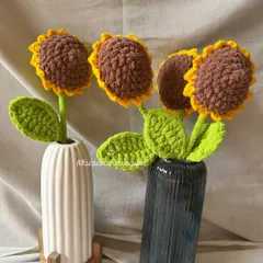 Our chunky yarn crochet sunflowers styled in modern black and white vases. Their bold texture and cheerful look can brighten any room.