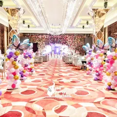 We created a grand butterfly-lined walkway to welcome guests. These colorful balloon pillars topped with large butterfly balloons transformed the hotel ballroom into a magical pathway for Aarṇa's fairyland party.