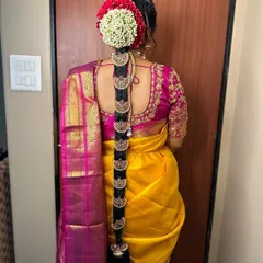 A beautiful South Indian bridal braid adorned with traditional `Jada` billai, the series of gold discs that run down the length of the braid. The look is completed with fresh flowers.