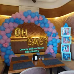 This is a simple yet elegant baby shower arch I set up in a restaurant. The pink and blue balloons are perfect for a gender-neutral theme, and I added "Oh Baby" foil balloons and matching B-A-B-Y boxes.