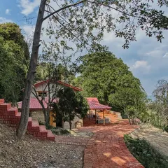 The restored Sargakhet Handicraft Centre nestled in the hilly terrain of Uttarakhand. The project involved renovating the stone structure and landscaping the surrounding area to create an accessible and inviting destination.