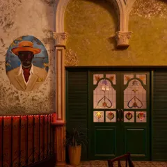 Details at Los Cavos include custom artwork and stained-glass doors set against distressed, textured walls. These elements work together to build an authentic, time-worn aesthetic that feels both rustic and refined.