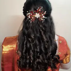 A beautiful half-up, half-down hairstyle with soft, defined curls. This romantic look is very popular for pre-wedding events and is finished with a sparkling floral hairpiece.