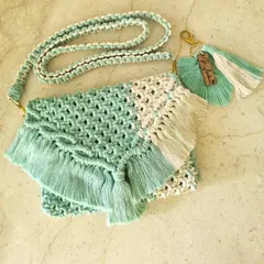 This two-tone macrame sling bag in mint and cream is all about fresh, boho vibes. We've paired it with a matching leaf keychain to create a complete, effortlessly chic look.