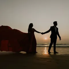 A beautiful silhouette of a couple walking on the beach at sunset. This is a timeless shot for any pre-wedding album, and I can help you find the perfect flying gown for it.