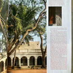 An exterior view of the restored 1873 school building, featured in a magazine. The text explains our process, which began with an archaeological-like study to understand the original structure and style, ensuring our conservation work was deeply informed by history.