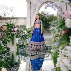 A vision in royal blue walking on water. This bride makes her way to the mandap on a spectacular mirrored aisle lined with flowers, her reflection creating a stunning, ethereal effect for her grand entrance.