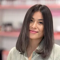 A beautiful ash hair color on a sleek, medium-length bob. The cut is simple and elegant, letting the cool-toned color be the star.