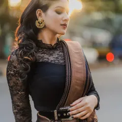 A close-up bridal portrait with the warm, out-of-focus lights of the city at sunset. The golden light and bokeh effect create a dreamy and sophisticated look.