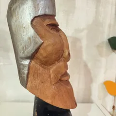 A profile view of our hand-carved wooden sculpture, showing the strong lines of the face and the texture of the beard, all shaped by hand.