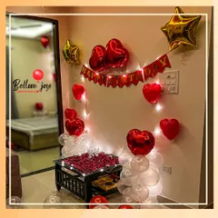 I can turn any room into a romantic retreat for a birthday surprise. This bedroom decoration includes a "Happy Birthday" banner, heart and star-shaped foil balloons, fairy lights, and a table centerpiece with delicate rose petals.