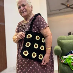 A proud smile from Dadi with our sunflower granny square tote. This black version is a classic, perfect for adding a touch of sunshine to your day.