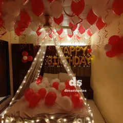 A classic romantic birthday surprise setup in red and white. We decorated the room with a fairy light canopy, 'HAPPY BIRTHDAY' foil balloons, and dozens of balloons on the bed and ceiling.