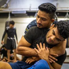Drilling the rear naked choke, one of the most effective submissions in combat sports. Two of our students practice the technique during a seminar, focusing on the grip and body positioning needed to finish the fight.