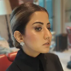 This angle highlights the smooth, flawless finish of the foundation and the elegant lines of the low bun, demonstrating our attention to detail.