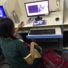 A student works on an AI project, using a camera and computer to run a program that involves image recognition.