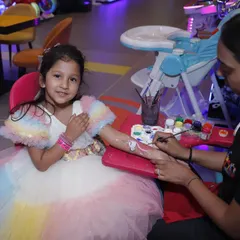 A little girl gets a beautiful design from our tattoo and face painting artist. This is a very popular add-on that makes kids feel special and adds a creative touch to the party.