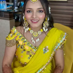 A close-up of the fresh and creative Haldi makeup, with a pop of yellow on the eyes and beautiful shell jewelry.