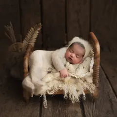 I have a collection of tiny, baby-safe wooden beds that create the most adorable scenes. This little one looks so peaceful sleeping in a cozy knit outfit on a bed of soft wool.