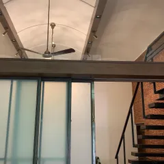 By introducing vaulted ceilings and translucent glass partitions, we fundamentally changed the experience of this 70-year-old house. The design allows light to travel deep into the floor plan, creating an airy, interconnected space that feels both modern and respectful of the original structure.