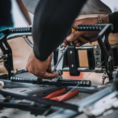 Every detail matters. A mechanic makes fine adjustments to the pedal assembly, ensuring the driver has perfect control over throttle and braking inputs.