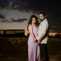 A moody and romantic shot at dusk. The dramatic sky and the couple's close embrace create a powerful and emotional pre-wedding photograph.