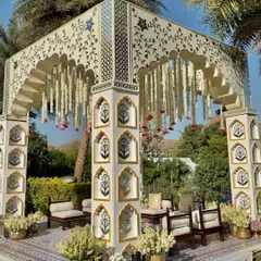 A closer look at the intricate details, from the hand-painted motifs on the pillars to the delicate canopy of hanging tuberoses.