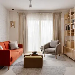 This living room is a perfect example of a 'Soulful Sanctuary'. I used a warm burnt orange sofa, an olive green ottoman, and a mix of textures to create a comfortable and practical open-plan space that feels both stylish and deeply inviting for the entire family.