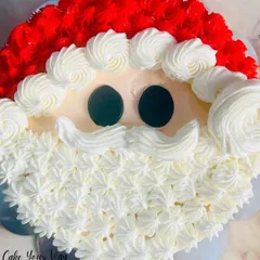 Ho ho ho! This pull-apart cupcake cake is designed to look like Santa Claus, with fluffy white buttercream for his beard and a bright red hat. It's a fun centerpiece for any Christmas party.