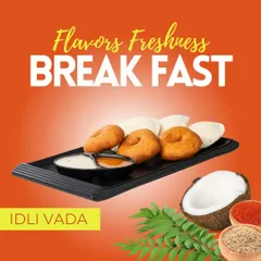 A classic plate of Idli Vada, showcasing the soft texture of our steamed rice cakes and the golden-brown crispiness of our lentil fritters. This is a foundational dish of our South Indian offerings.
