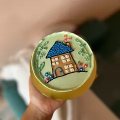 This bento cake features a cozy little house hand-piped with buttercream. It's a sweet and simple design that feels like home.