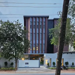 A view of the RINAC HQ building from the street, showcasing the modern architectural facade. The design balances solid massing with vertical window arrangements to create a distinctive and professional corporate presence.