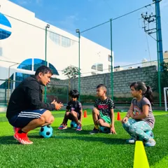 Coaching is more than just drills. It's about connection. Here, I am explaining a concept to some of our youngest players. These moments of mentorship are key to building their confidence and love for the game.