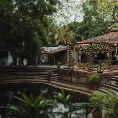 A wide view of the Pond Pavilion and Kalyani, showing the scale of the space and its harmonious integration with nature.