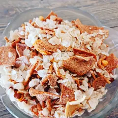 A delightful roasted poha (rice flake) chivda, mixed with nuts and spices for a light and flavorful snack.