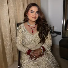 A seated portrait of my client for her reception. The makeup is soft and glamorous, with a focus on radiant skin and defined eyes.