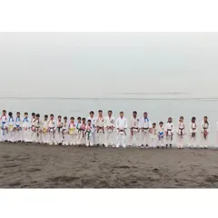 A panoramic group photo of all participants at our winter training camp, held at the beach. Training in nature builds resilience and a different kind of strength.