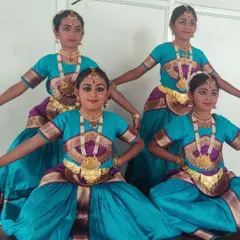 My young Bharatanatyam dancers striking a classic pose during their Onam celebration performance. They learn not just the steps, but also the discipline and grace that comes with classical dance.