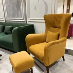This mustard yellow wingback armchair with an accompanying ottoman is the perfect reading chair. The high back provides support and a sense of privacy, while the vibrant color adds energy to the room.